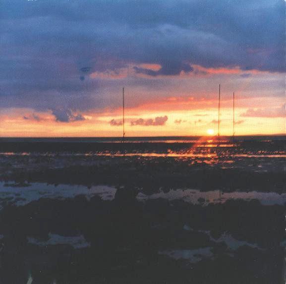 Photo of a sunrise. The landscape is bleak and plain with no housings in sight