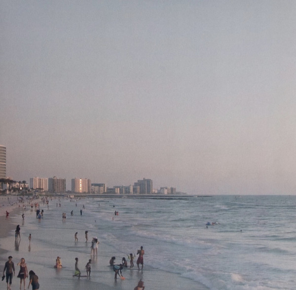 Photo of a beach landscape, a city coastline where you can see the buildings from afar erected near the beach.